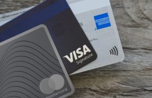 A conceptual illustration showing a judge's gavel entangled in digital payment networks like Visa and Mastercard, with the Turkish TROY logo emerging as a bright, secure alternative.