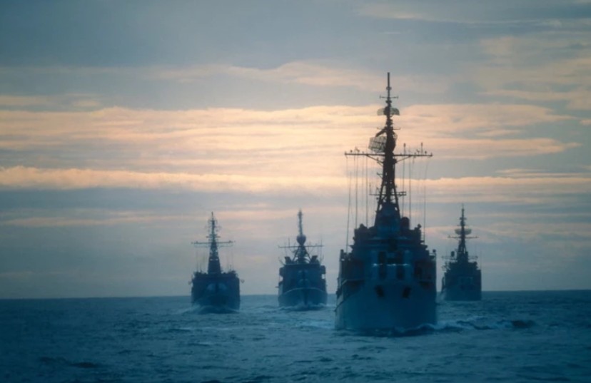 A US Navy guided-missile destroyer and the USS Abraham Lincoln positioned near the entrance of the Strait of Hormuz.