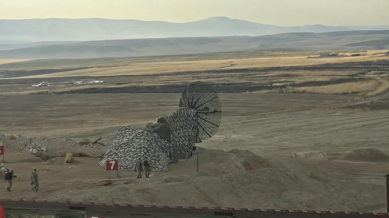 A dish antenna under camouflage netting at the General Nahit Şenoğul Firing and Training Area, Polatlı. Photo: Envanter Medya
