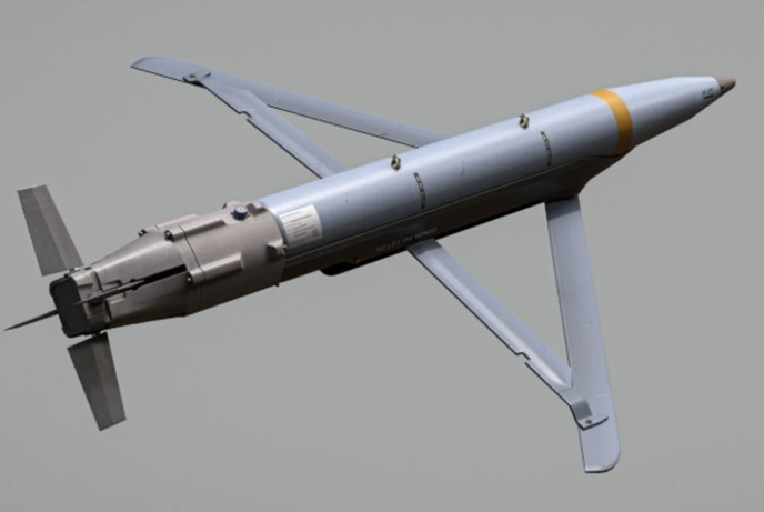 A Ground-Launched Small Diameter Bomb (GLSDB) mid-flight, showing the separation of the M26 rocket booster and the deployment of the GBU-39 glide bomb's wings.